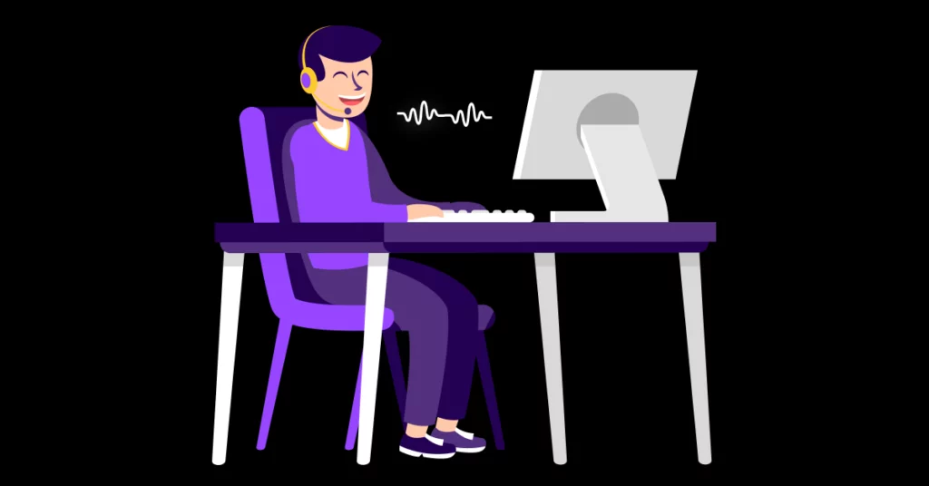 A person with short dark hair, wearing a headset and purple clothing, sits at a desk typing on a computer. Sound waves near their mouth indicate they are speaking or leaving effective sales voicemails in a virtual setting. VoiceDrop Ringless Voicemails